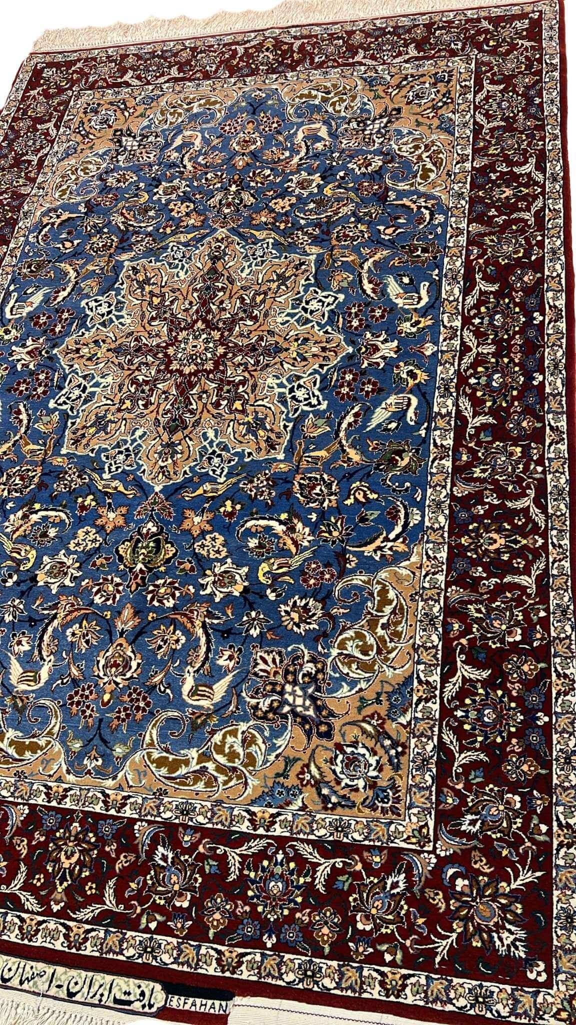 "Elegant Persian Seirafian rug with a floral medallion design in shades of blue, beige, and burgundy, crafted with silk and wool."